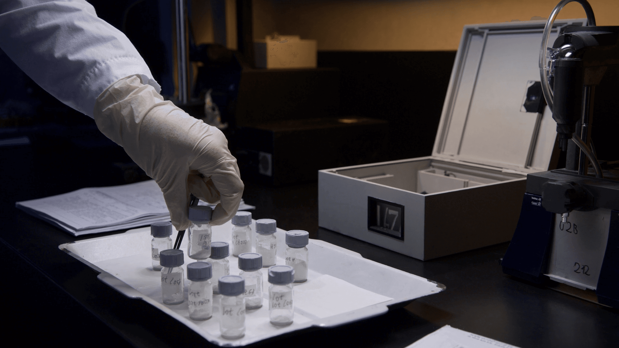 Lyophilized GLP-1 peptide vials in the autosampler tray at the Agilent 1290 HPLC bench