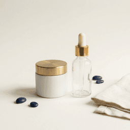 Cosmetic jar with brushed-gold lid and a serum dropper bottle